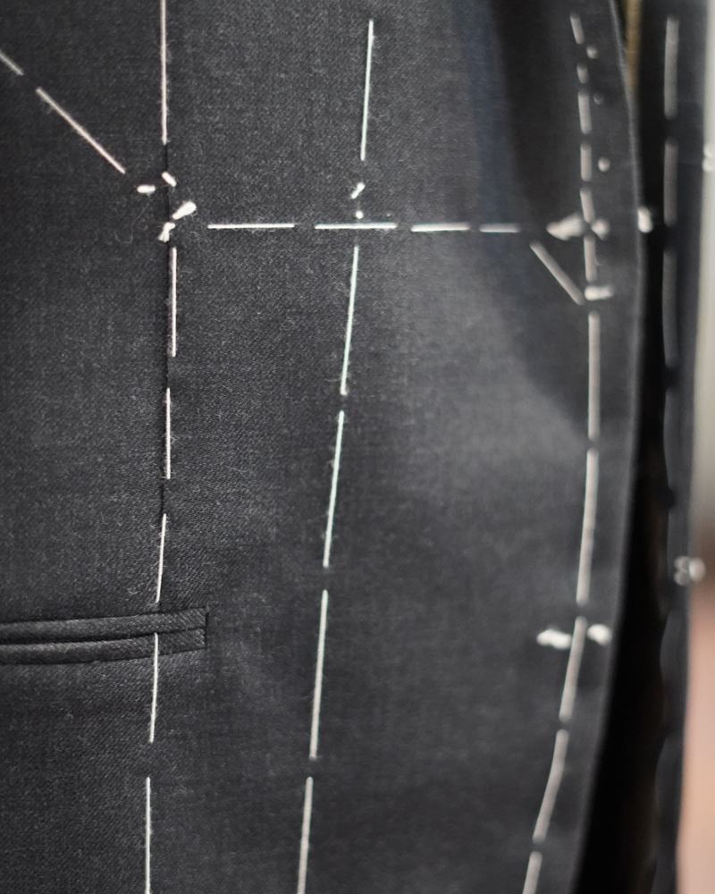 Chalk marks on a suit at the basted stage